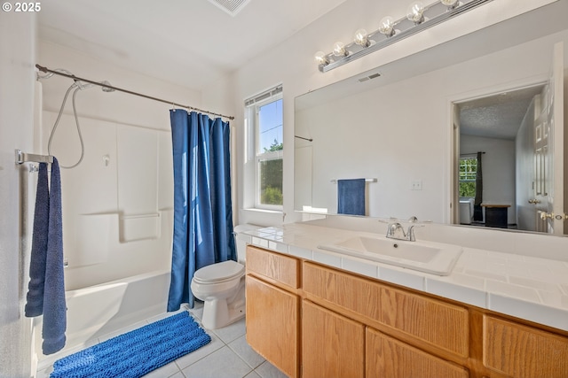bathroom with toilet, visible vents, a wealth of natural light, and tile patterned flooring
