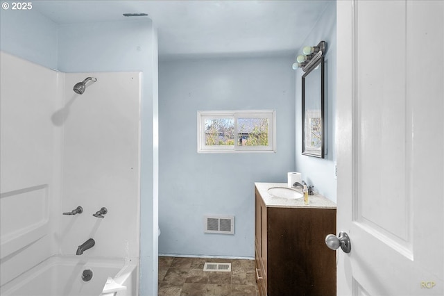 full bath with stone finish flooring, shower / tub combination, vanity, and visible vents