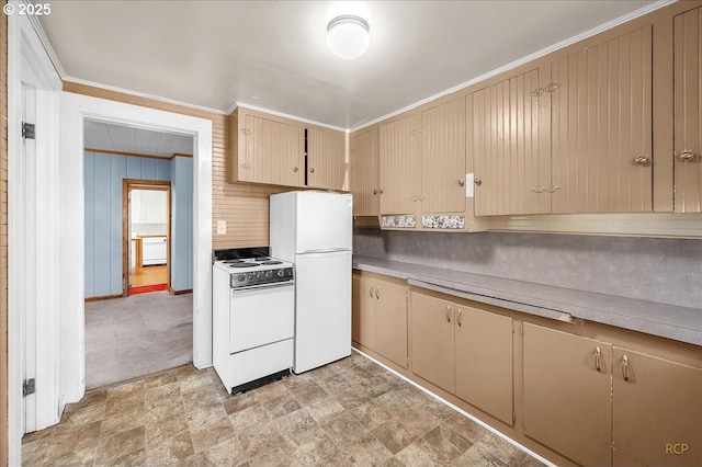 kitchen with light countertops, ornamental molding, stone finish floor, wooden walls, and white appliances