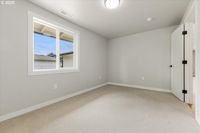 unfurnished bedroom with light colored carpet, baseboards, and visible vents