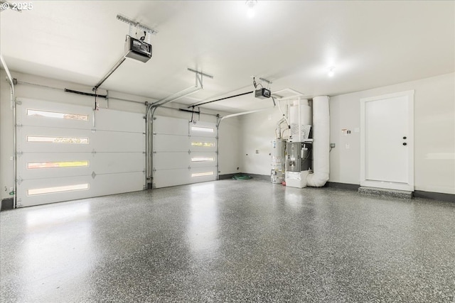 garage featuring baseboards, a garage door opener, and gas water heater