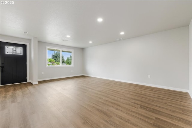 foyer entrance with baseboards, recessed lighting, and wood finished floors