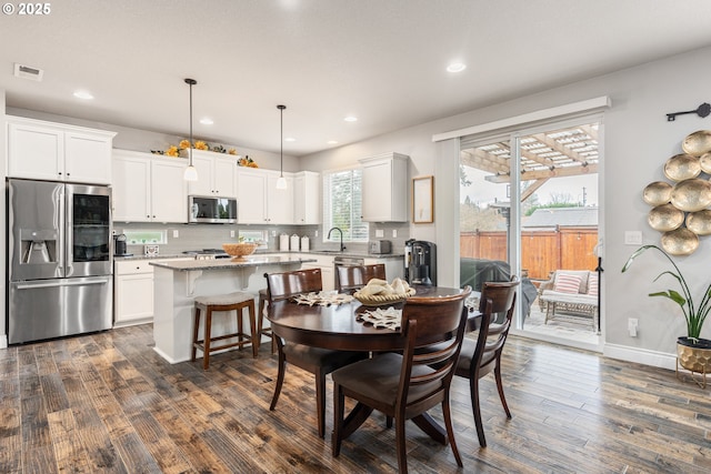 dining area featuring dark hardwood / wood-style floors and sink