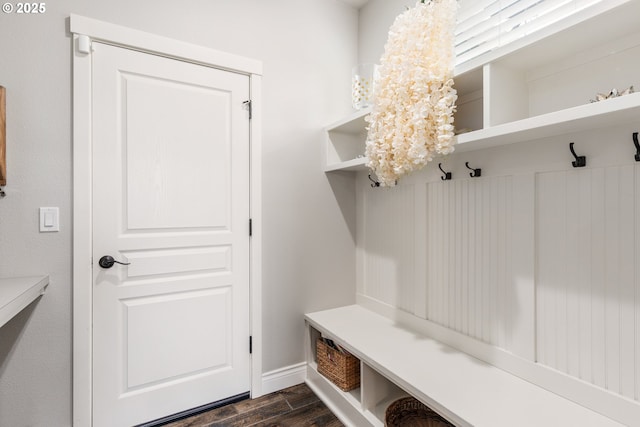 mudroom with dark wood-type flooring and an inviting chandelier