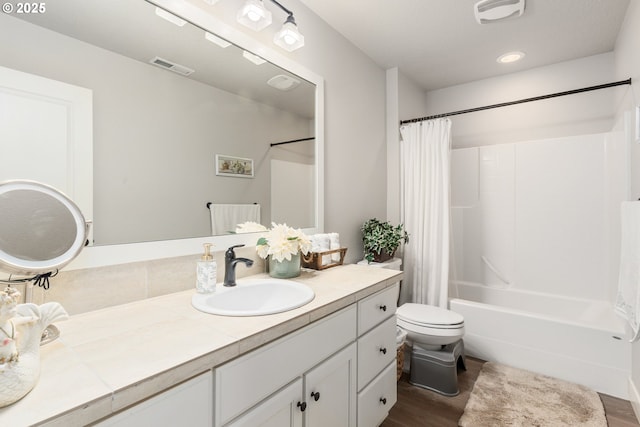 full bathroom with toilet, wood-type flooring, shower / bathtub combination with curtain, and vanity