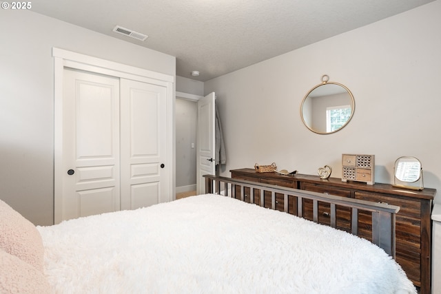 bedroom with a closet and a textured ceiling