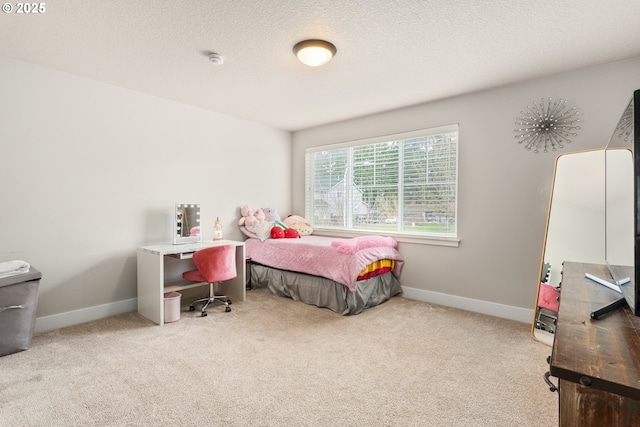 bedroom with light carpet and a textured ceiling