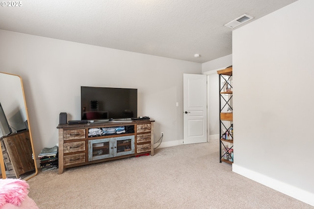 living room featuring light colored carpet and a textured ceiling