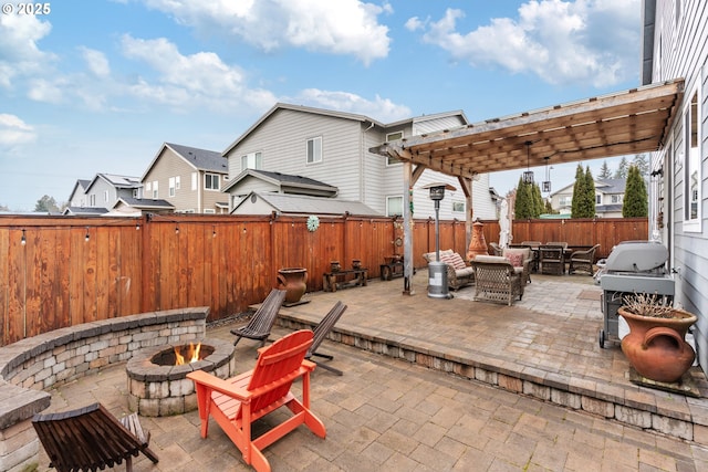 view of patio / terrace featuring a grill, a pergola, and a fire pit