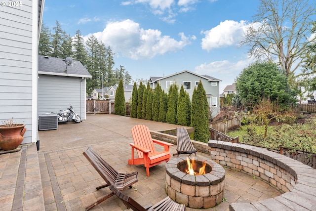 view of patio / terrace featuring an outdoor fire pit and central AC unit