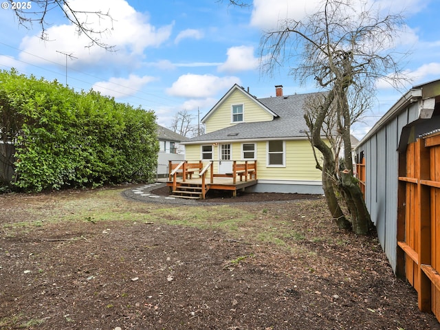 back of property featuring a wooden deck