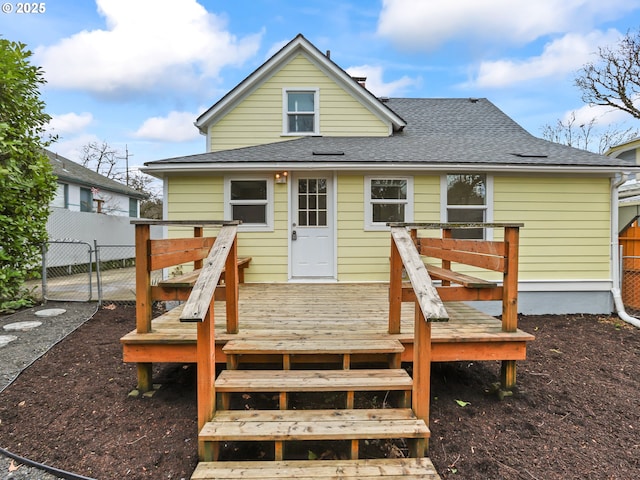 back of house featuring a wooden deck