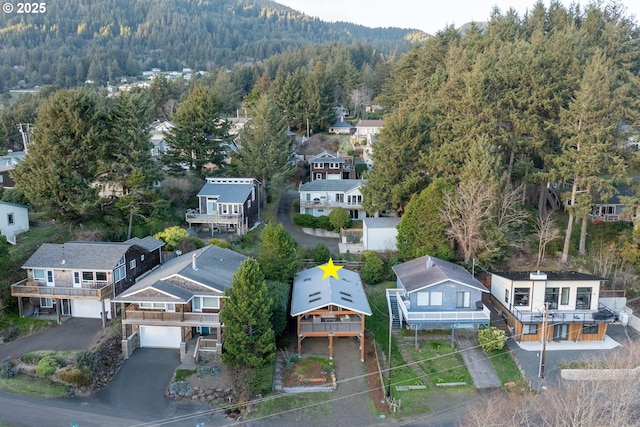 aerial view featuring a forest view and a residential view