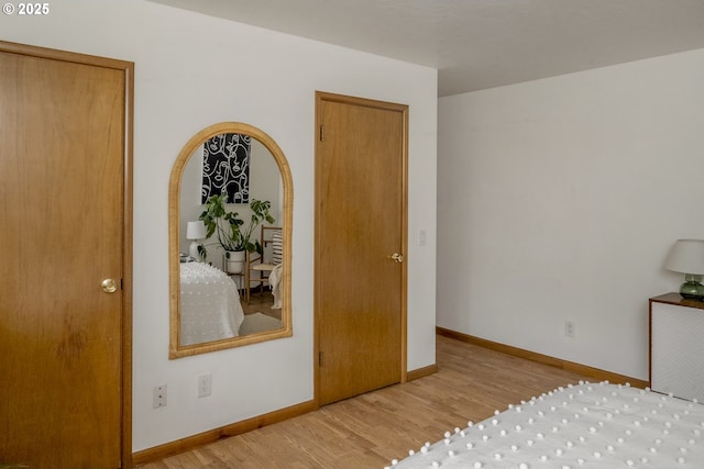 bedroom featuring wood finished floors and baseboards