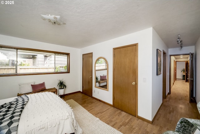 bedroom with wood finished floors and baseboards