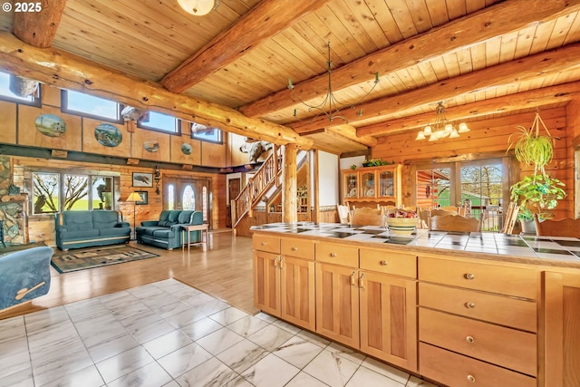 95787 Territorial Hwy, Monroe, OR 97456 - kitchen with tile countertops, wood walls, plenty of natural light, a chandelier, and open floor plan