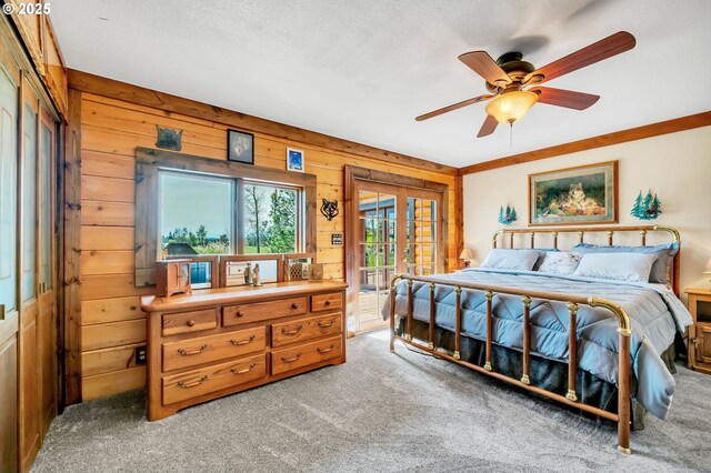95787 Territorial Hwy, Monroe, OR 97456 - bedroom featuring wood walls, light carpet, access to exterior, and a ceiling fan