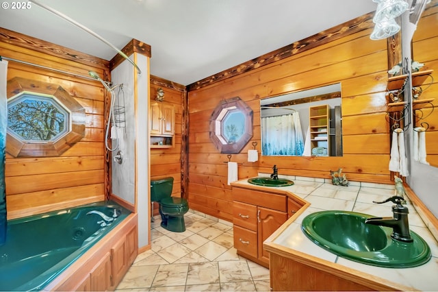95787 Territorial Hwy, Monroe, OR 97456 - bathroom featuring wooden walls, vanity, marble finish flooring, toilet, and a combined bath / shower with jetted tub