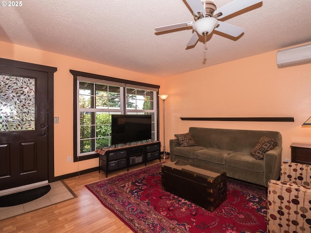 17758 SE Washington St, Portland, OR 97233 - living room with an AC wall unit, wood finished floors, a textured ceiling, and ceiling fan