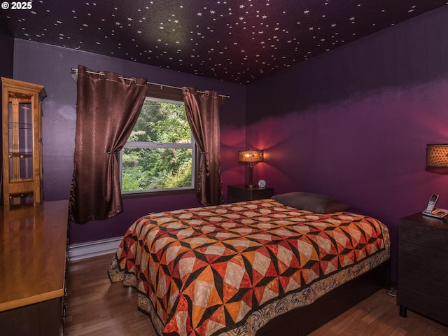 17758 SE Washington St, Portland, OR 97233 - bedroom featuring a baseboard heating unit and wood finished floors