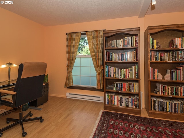 17758 SE Washington St, Portland, OR 97233 - office area with baseboard heating, wood finished floors, and a textured ceiling
