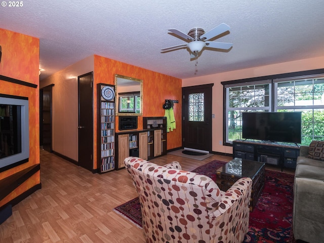 17758 SE Washington St, Portland, OR 97233 - living area featuring wood finished floors, a textured ceiling, a ceiling fan, and baseboards