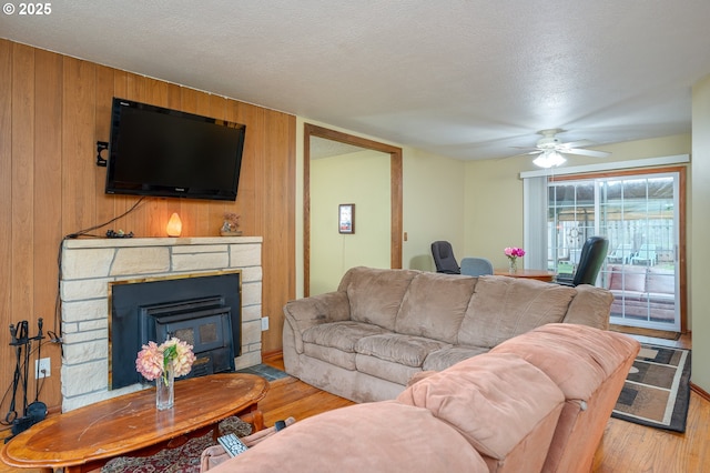 11102 SE 51st Ave, Milwaukie, OR 97222 - living area featuring light wood finished floors, ceiling fan, wood walls, and a textured ceiling