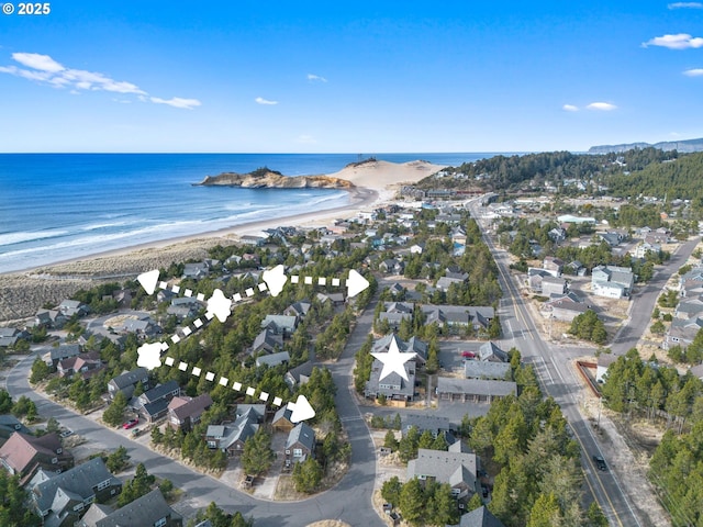 birds eye view of property featuring a water view and a beach view