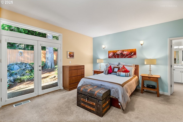 carpeted bedroom featuring connected bathroom, access to exterior, and french doors