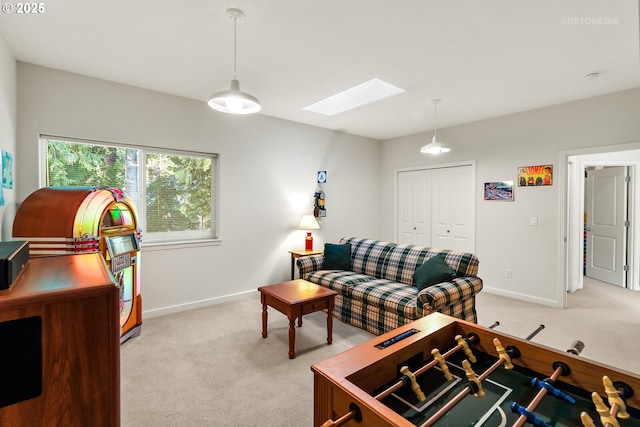 living room featuring light colored carpet and a skylight