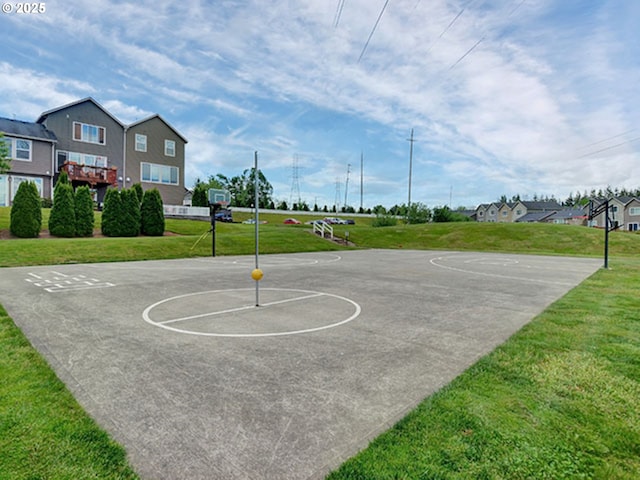 view of basketball court with community basketball court and a lawn