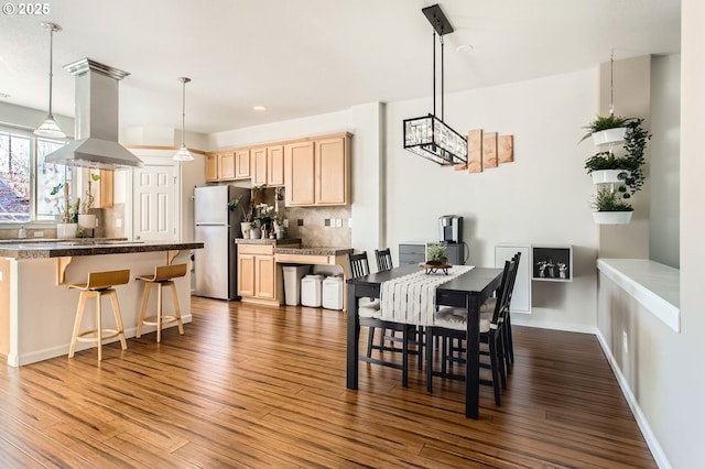 dining room featuring recessed lighting, baseboards, and dark wood-type flooring