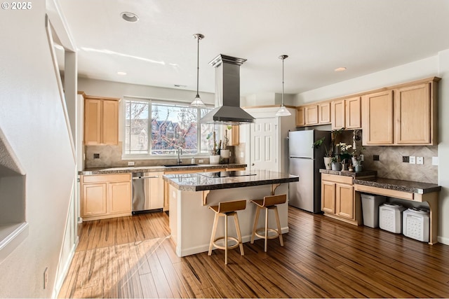 kitchen featuring light brown cabinets, island exhaust hood, stainless steel appliances, and wood finished floors