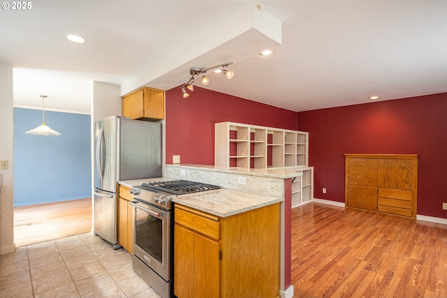 1444 Russet Dr, Eugene, OR 97401 - kitchen with appliances with stainless steel finishes, a peninsula, light wood finished floors, recessed lighting, and light stone counters