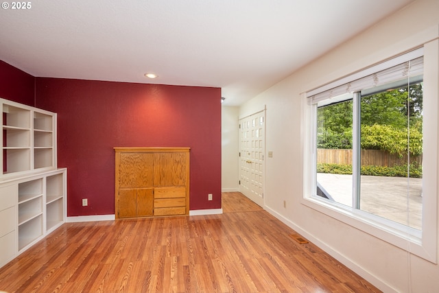 1444 Russet Dr, Eugene, OR 97401 - unfurnished living room featuring wood finished floors, recessed lighting, and an accent wall