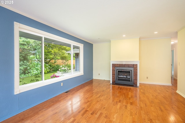 1444 Russet Dr, Eugene, OR 97401 - unfurnished living room featuring wood finished floors, ornamental molding, a tile fireplace, and recessed lighting
