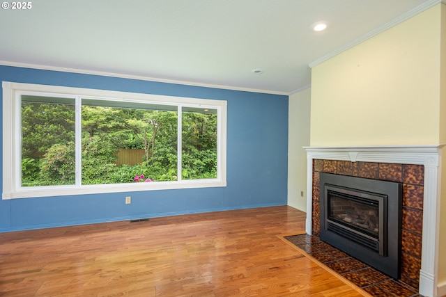 1444 Russet Dr, Eugene, OR 97401 - unfurnished living room with a fireplace, light wood finished floors, crown molding, and recessed lighting