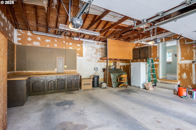 1444 Russet Dr, Eugene, OR 97401 - garage with a garage door opener and freestanding refrigerator
