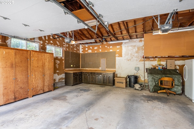 1444 Russet Dr, Eugene, OR 97401 - garage featuring a garage door opener and freestanding refrigerator
