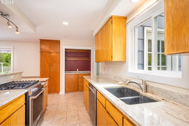 1444 Russet Dr, Eugene, OR 97401 - kitchen featuring stainless steel appliances, rail lighting, light stone counters, light tile patterned flooring, and recessed lighting