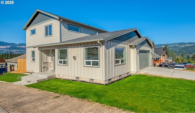 view of front facade featuring a front lawn, a garage, board and batten siding, a mountain view, and concrete driveway