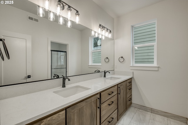 bathroom featuring visible vents, a sink, marble finish floor, and double vanity