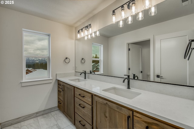 full bath featuring a sink, visible vents, double vanity, and marble finish floor