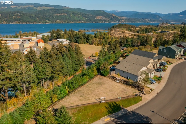 bird's eye view with a wooded view, a residential view, and a water and mountain view