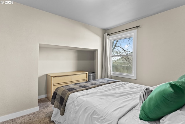 bedroom featuring carpet flooring and baseboards