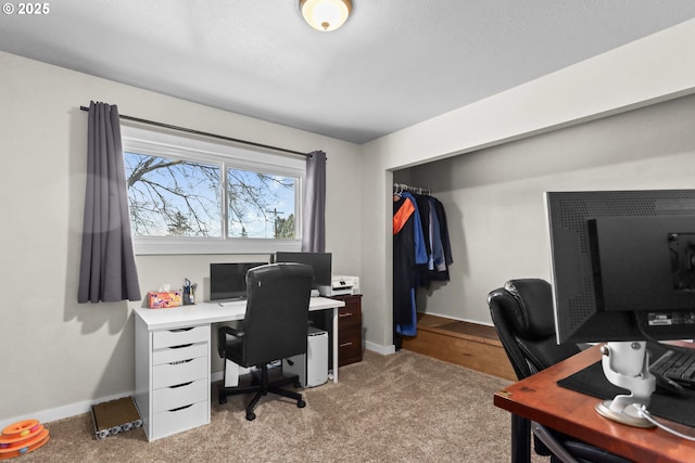 office space featuring light carpet and baseboards