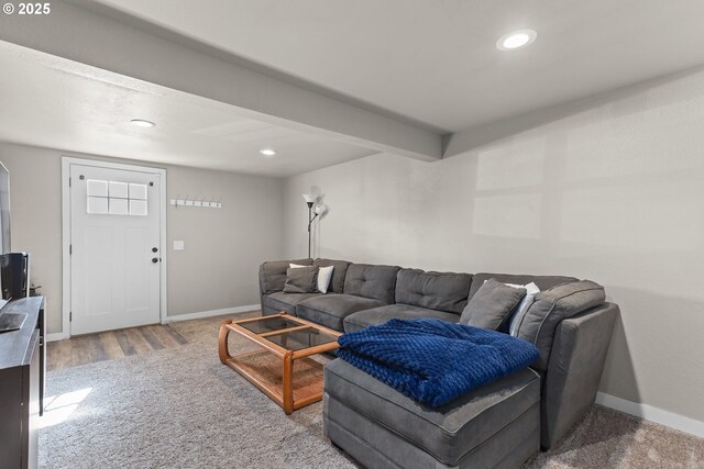 carpeted living room featuring beam ceiling, recessed lighting, and baseboards