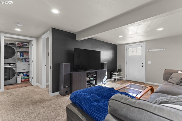 carpeted living room featuring beam ceiling, recessed lighting, baseboards, and stacked washer and dryer