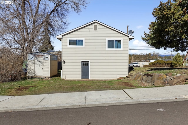 exterior space with an outdoor structure, a yard, and a shed