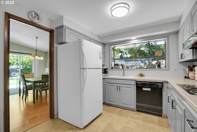 4420 NW 187th Ave, Portland, OR 97229 - kitchen featuring freestanding refrigerator, dishwasher, gray cabinets, and a chandelier